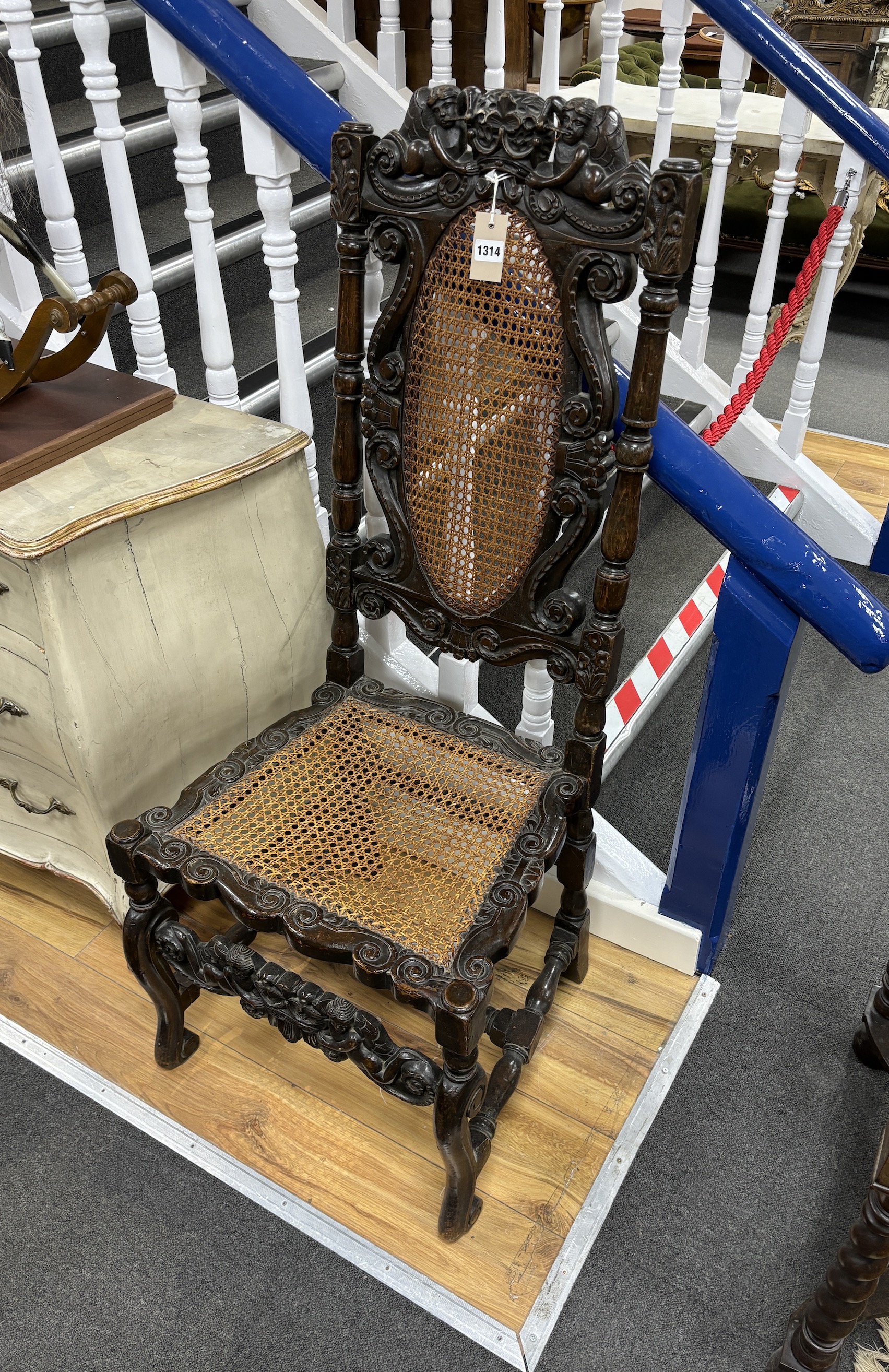 A Charles II carved walnut caned seat and back dining chair, c.1670, width 54cm, height 120cm, Please note this lot attracts an additional import tax of 5% on the hammer price